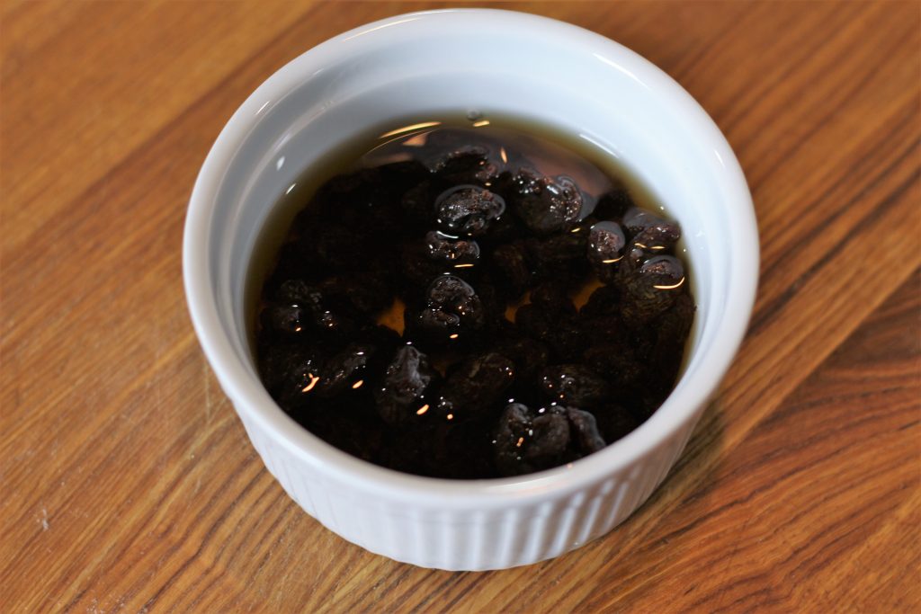 Rum poured into the bowl of raisins. 