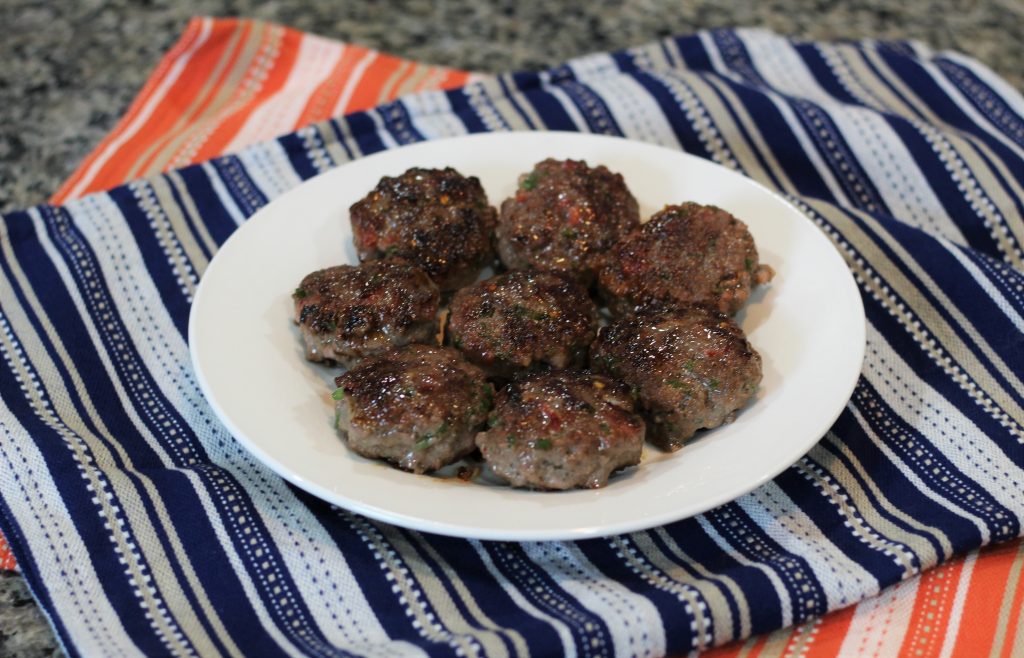 Patty sausages on a plate.