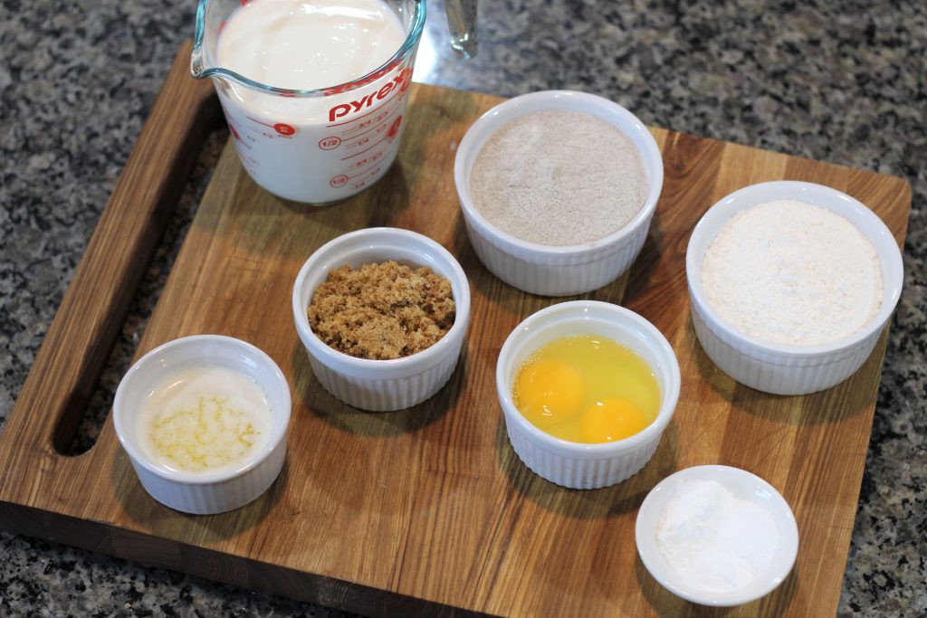 Ingredients of the pancakes laid out in bowls. 