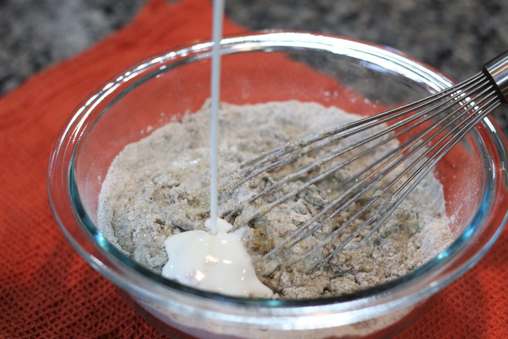 The buttermilk being poured into the batter. 