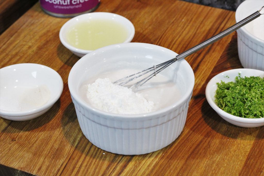 Coconut milk and cornstarch being mixed in a small bowl. 