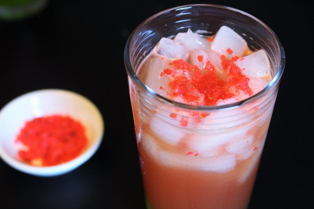 A top down shot of the finished drink, topped with red Pop Rocks. 