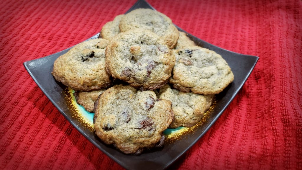 A plate with cookies piled on top. 