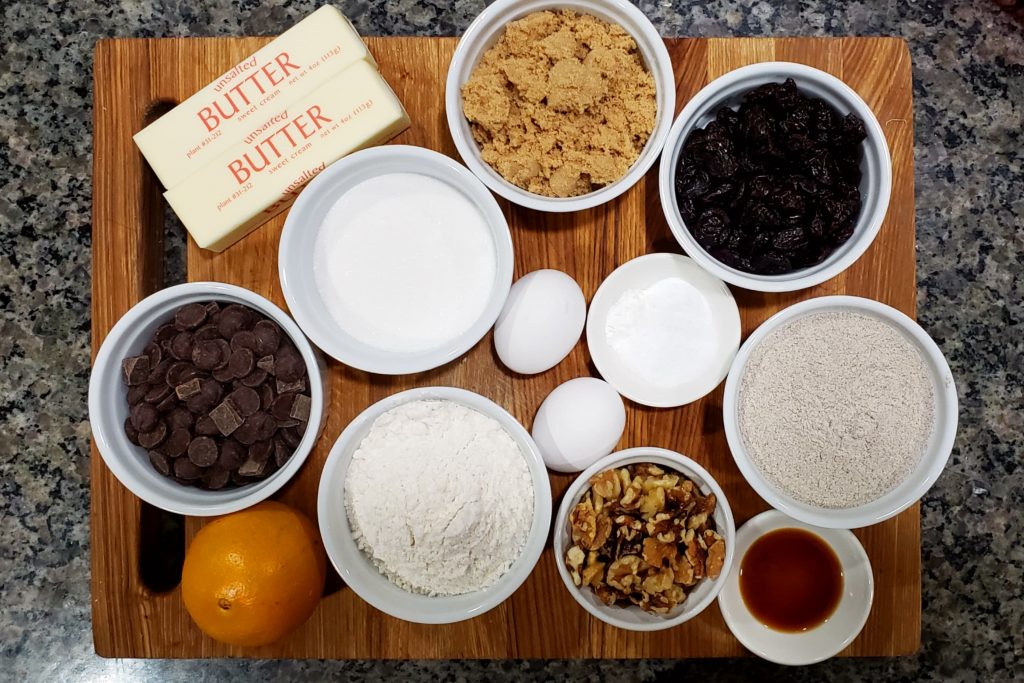 All of the ingredients in bowls on top of a cutting board.